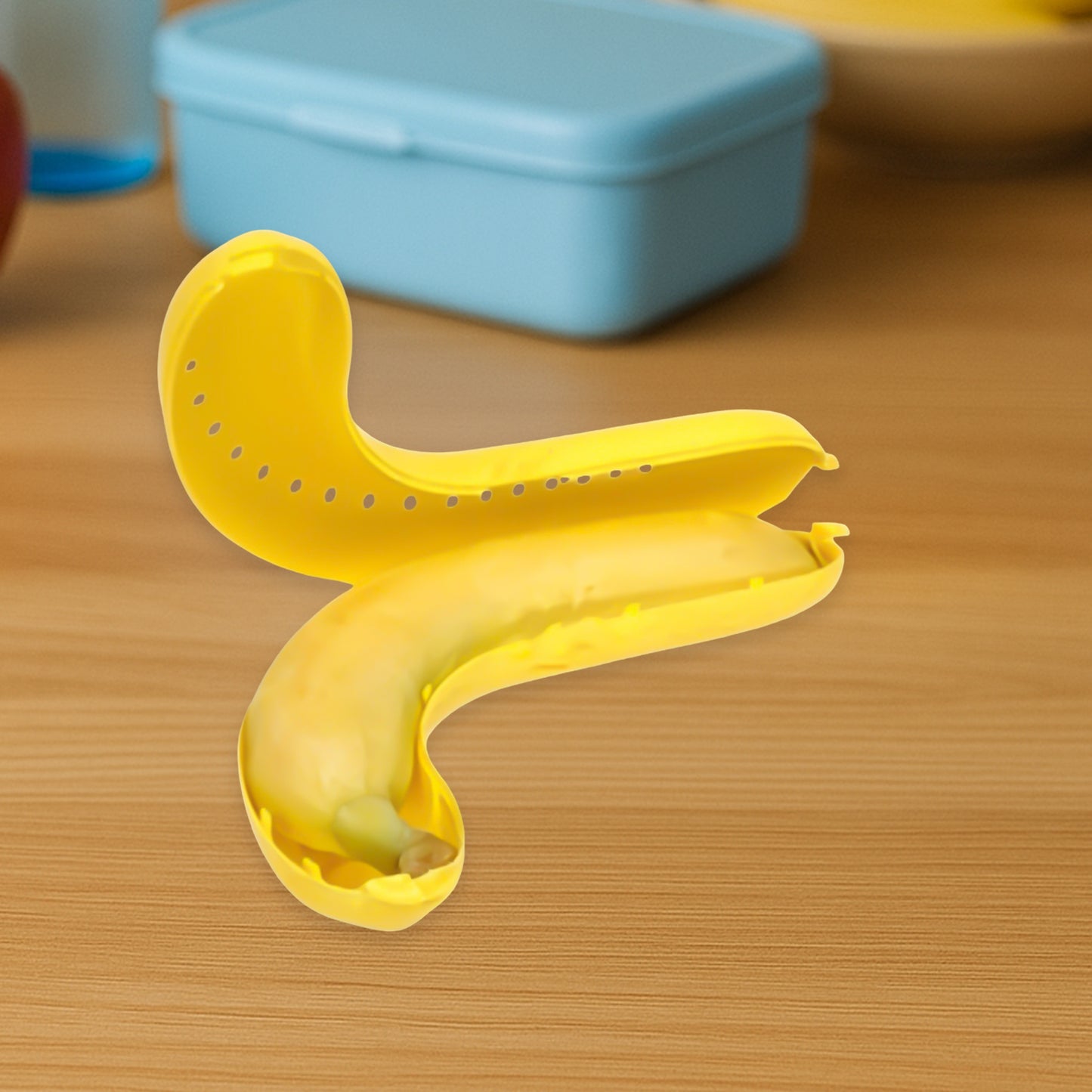 Yellow Wukusy banana-shaped lunch box, kitchen tool, with secure lid and compact design for easy food storage.