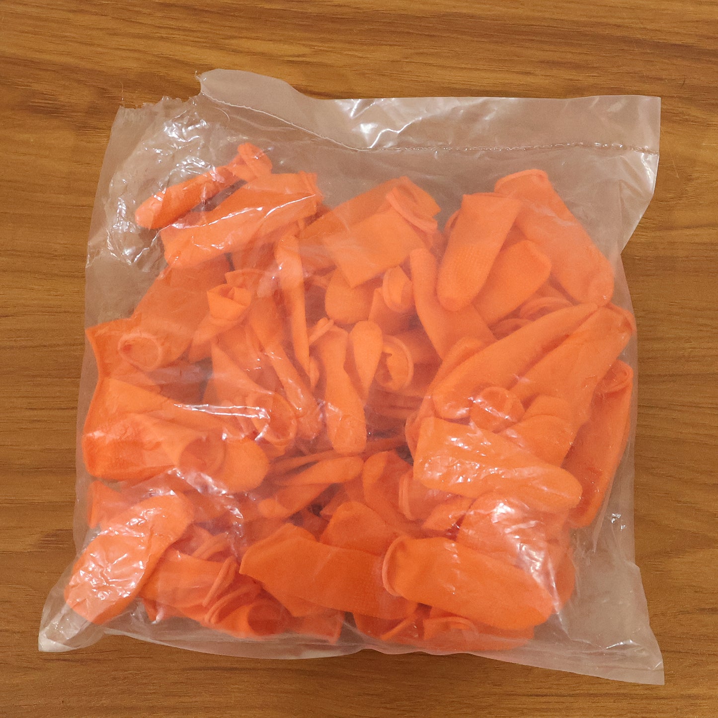 Pack of 100 Wukusy protective finger covers for multipurpose use, showing clear, flexible silicone finger covers on a white background.