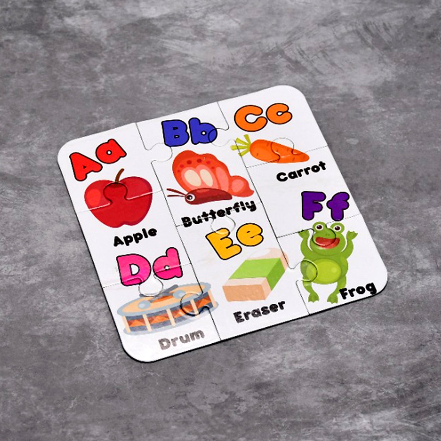 Wukusy Learning ABCD jigsaw puzzle toy for children, featuring four colorful puzzle pieces with letters and fun images.