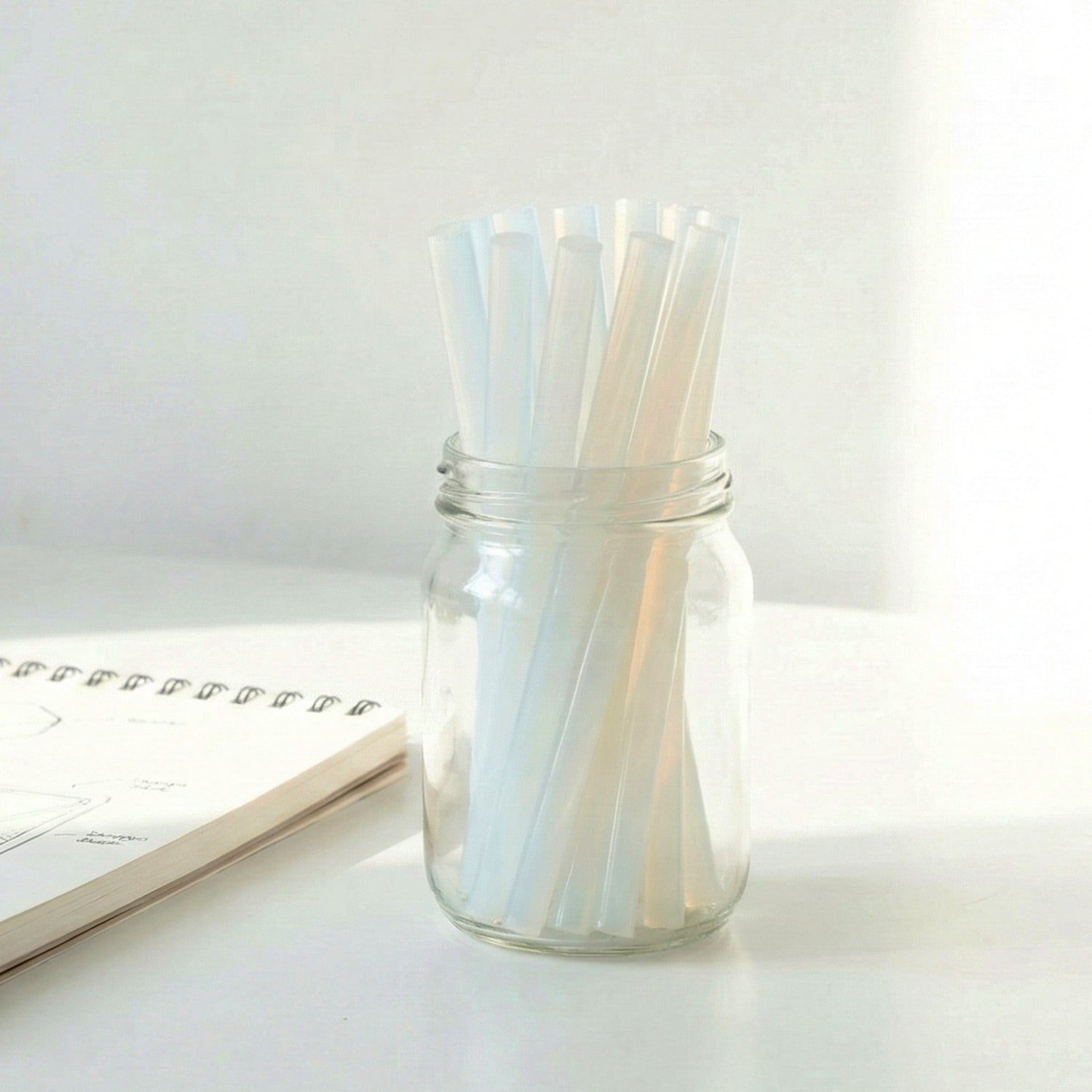 Wukusy hot glue stick set with 10 strong 20 cm adhesive glue sticks for crafting projects, shown stacked in a pile.