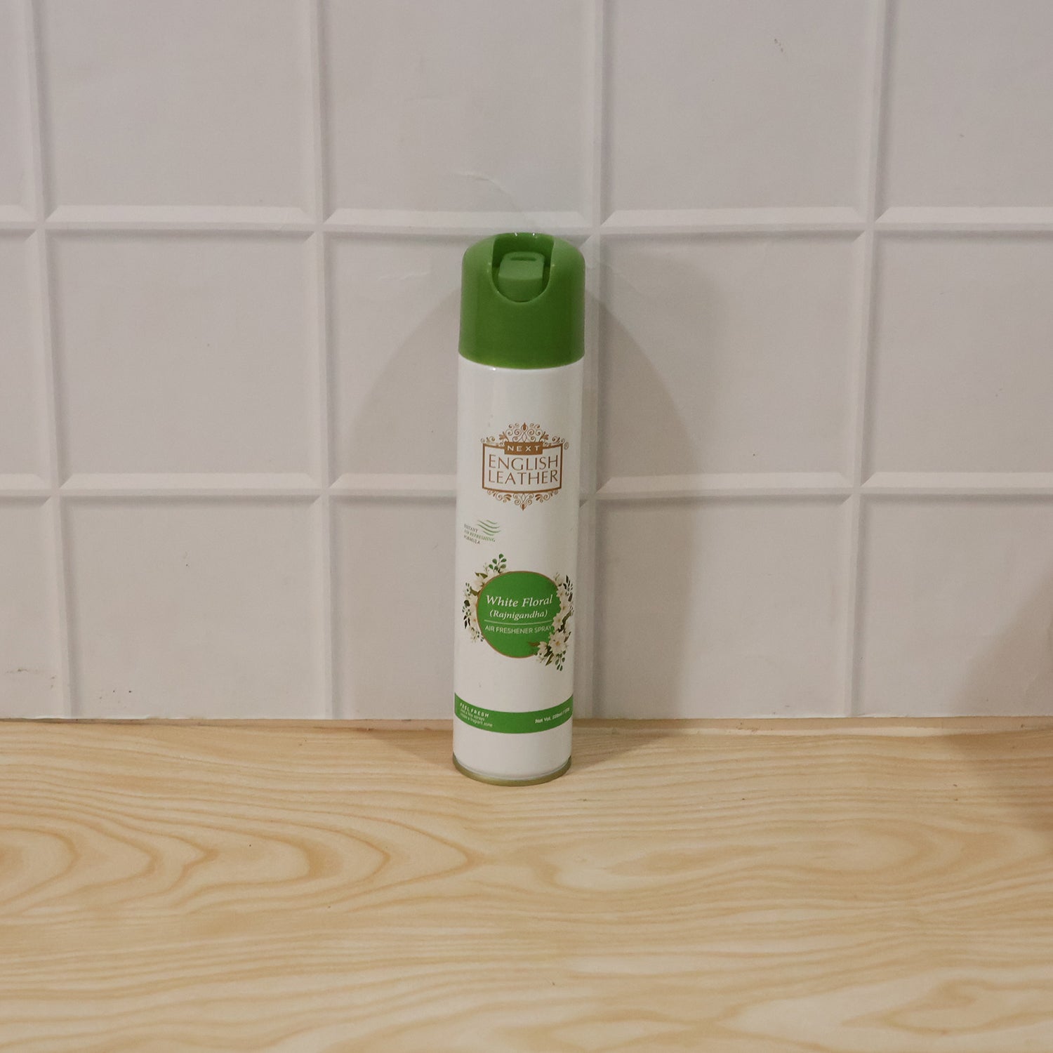Wukusy Next English Leather Floral Rajnigandha air freshener spray bottle, 220ml, with white floral design on the label