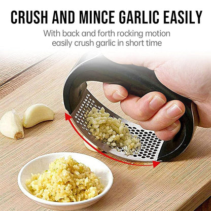 Wukusy heavy-duty garlic press tool with built-in spoon, stainless steel construction, showing the press and included spoon set.