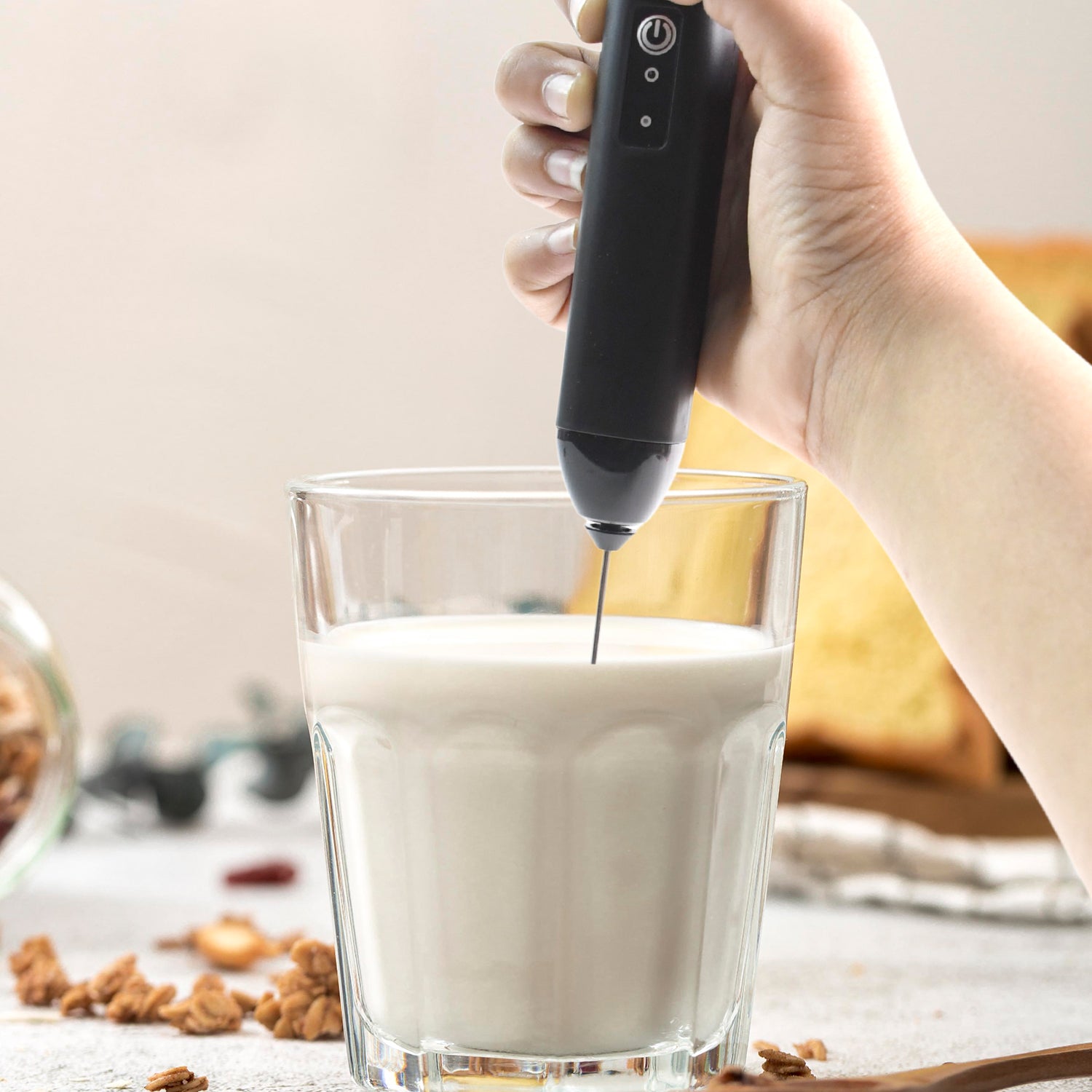 Wukusy small electric handheld milk frother with stainless steel whisk for creating creamy foam and drinks at home.