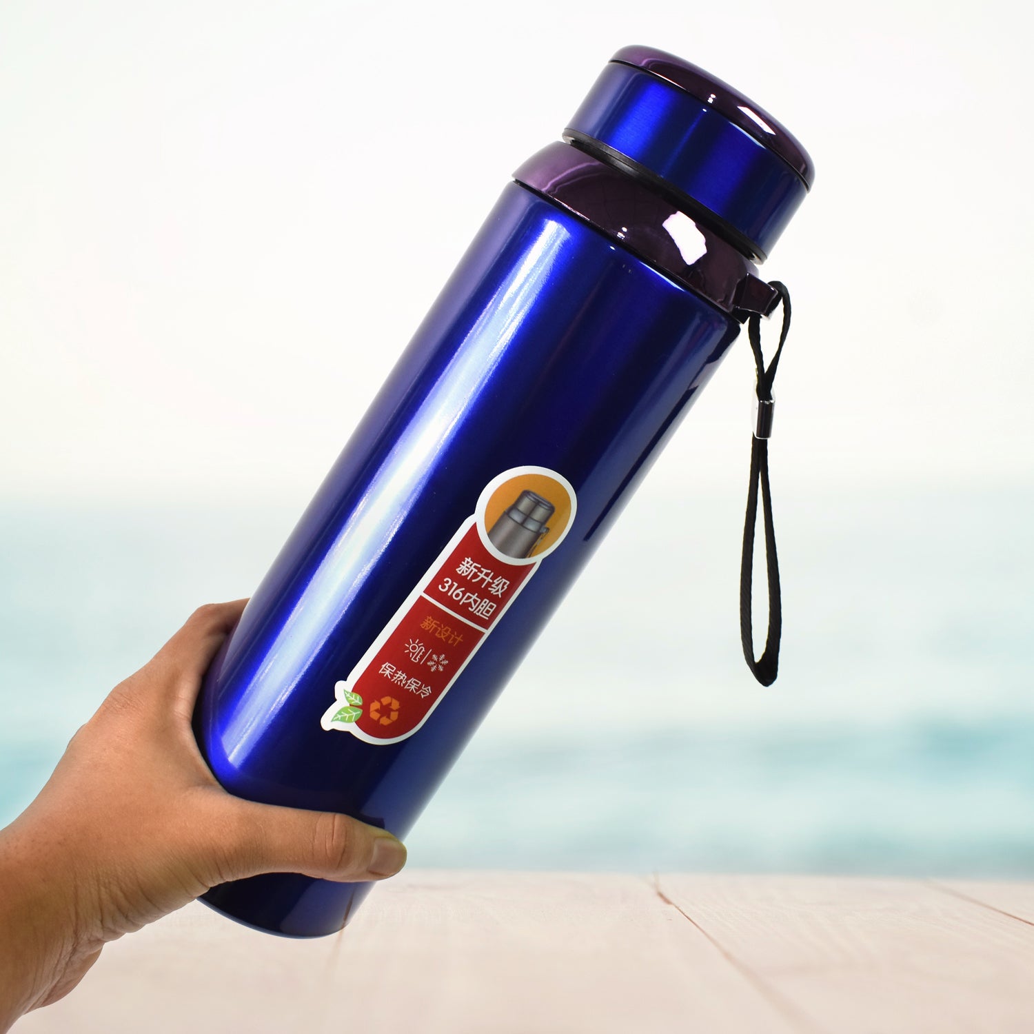 Wukusy vacuum insulated stainless steel bottle, 1000ml, double-walled design for hot and cold beverages, in a kitchen setting