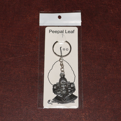 Silver Lord Ganesha sitting design keychain by Wukusy, featuring detailed Ganesha figure on a sleek keychain.