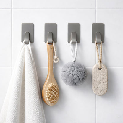 Set of six Wukusy self-adhesive wall hooks mounted on a wall, demonstrating their strong adhesive and versatile use.
