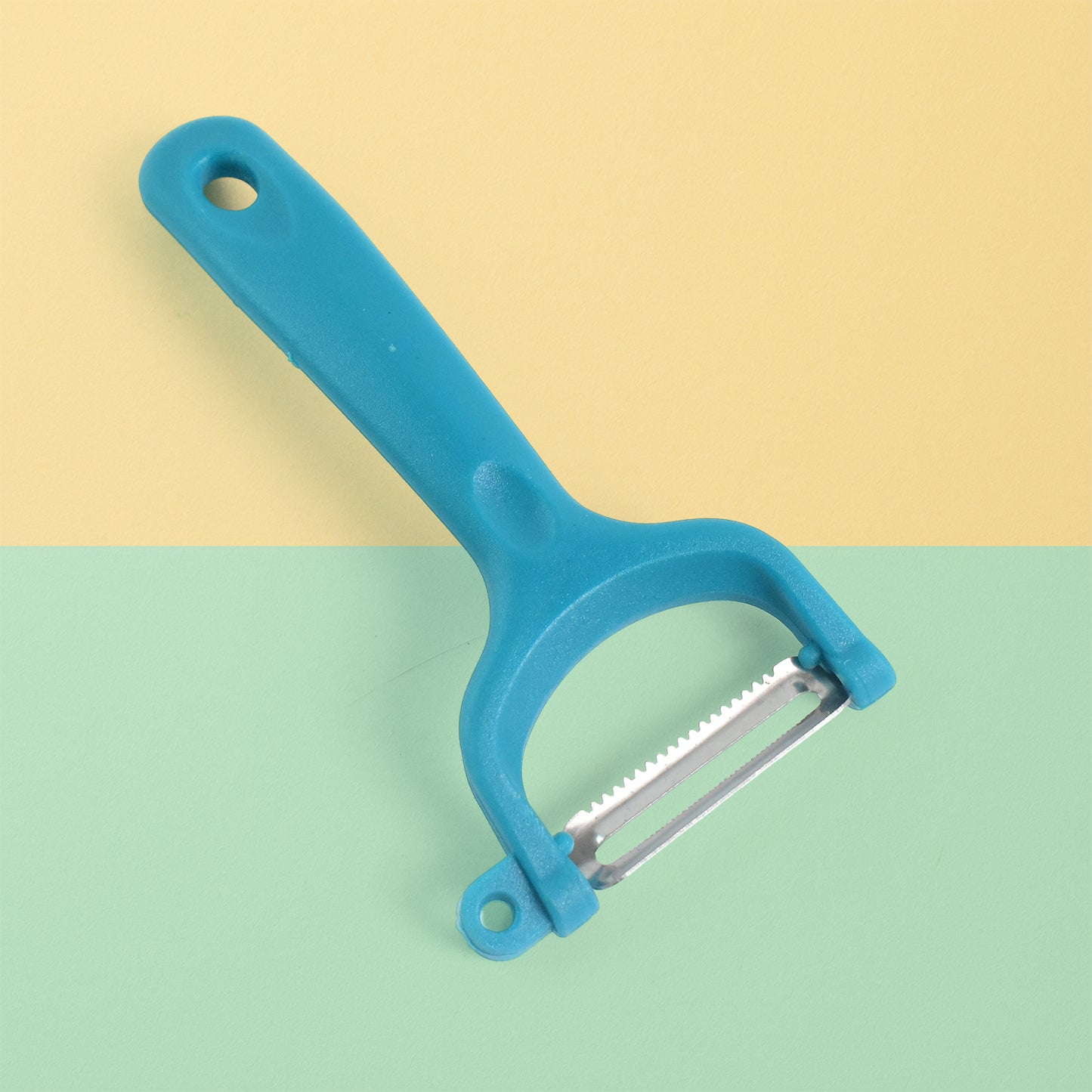 Wukusy Premium Ritu Peeler Plus in use, featuring a stainless steel blade for efficient vegetable and fruit peeling.