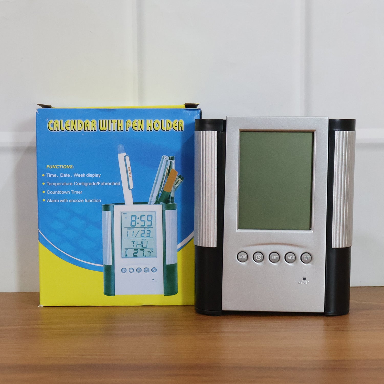 Wukusy multifunction digital calendar desk clock with pen holder, displaying time and date on a sleek modern design.