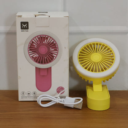 Wukusy portable rechargeable mini table fan with LED light, compact design, showing the fan with illuminated LED in a home setting.