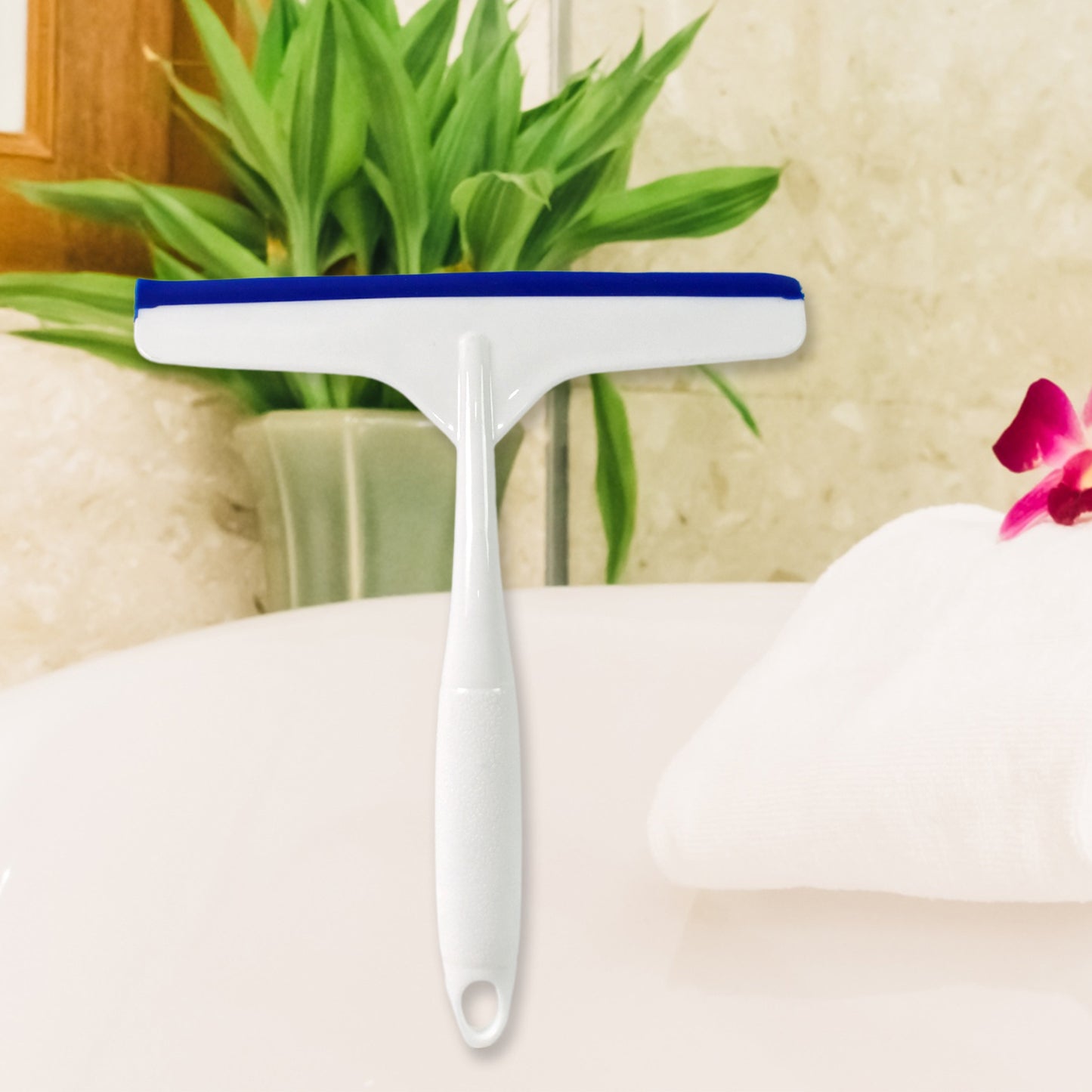 White plastic kitchen wiper by Wukusy, versatile cleaning tool for kitchen surfaces, shown in a clean, modern design image.