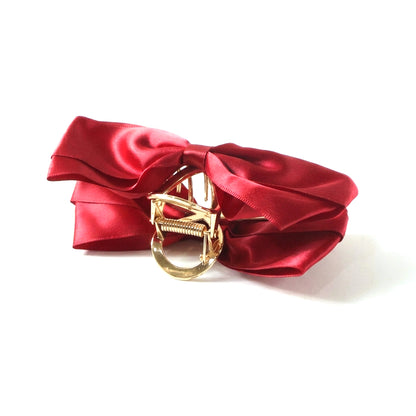 Wukusy satin bow hair claw clip for women, elegant black satin finish, holds hair securely with a decorative bow design