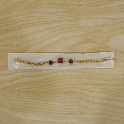 Gold-plated Rudraksha bead Rakhi with chain for brother, featuring intricate design and traditional craftsmanship.