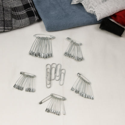 Assorted metal safety pins from Wukusy, including various sizes for sewing, craft projects, and securing fabrics or materials.