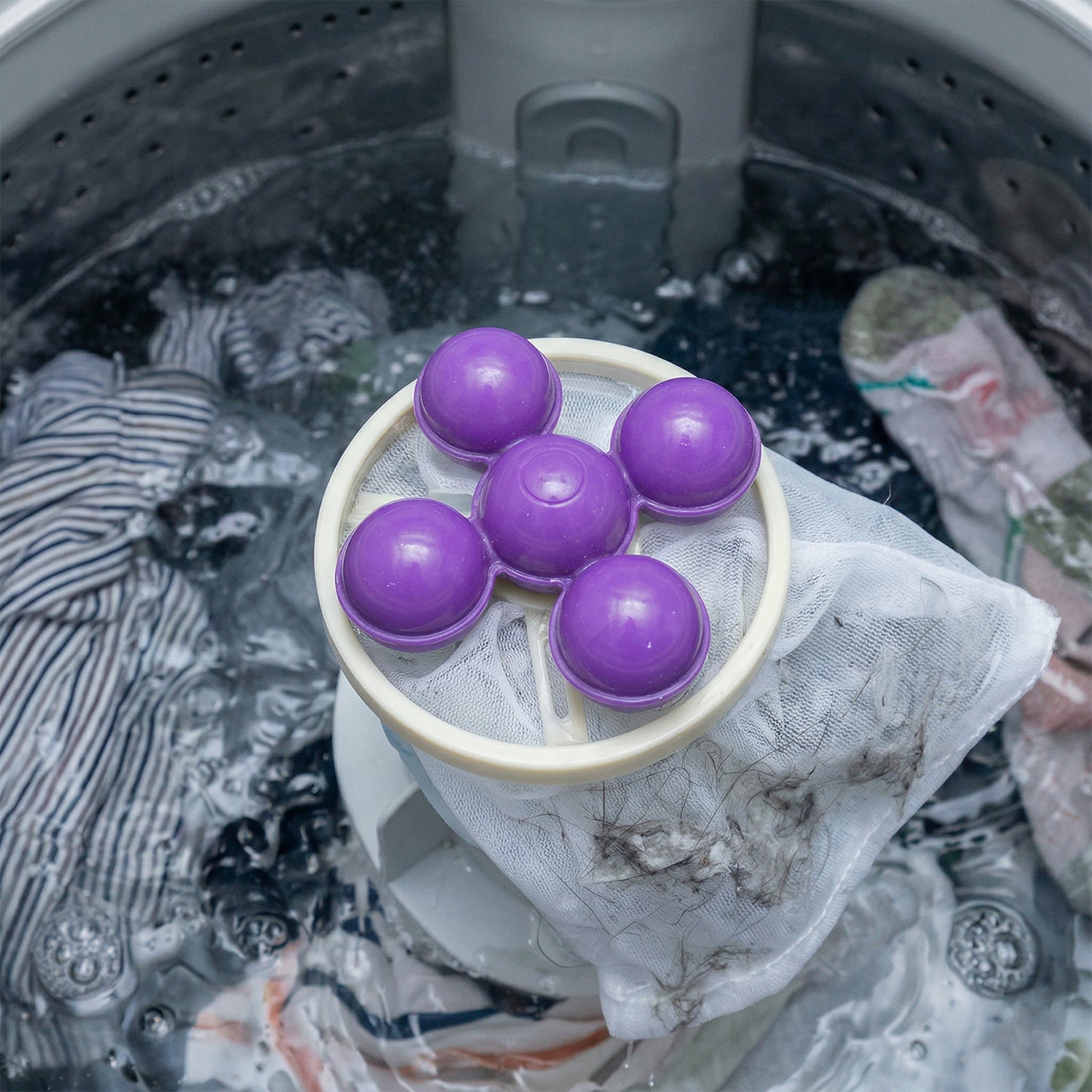 Reusable washing machine lint remover ball with mesh filter, large size, by Wukusy, shown in a close-up image.