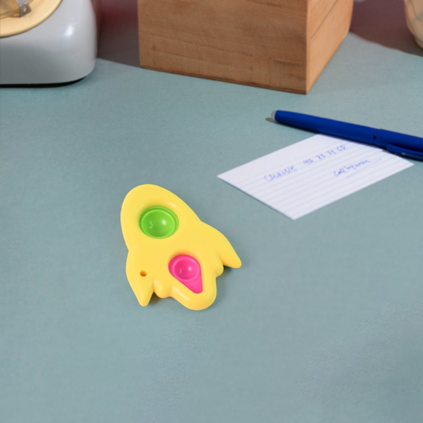 Rocket-shaped dimple keychain toy by Wukusy, featuring a colorful, textured dimple surface for tactile fun.