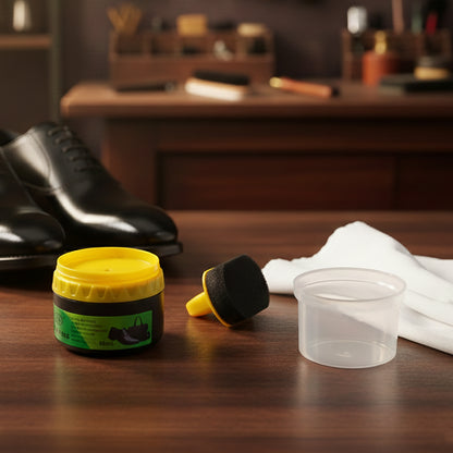 Black shoe polish cream with built-in sponge applicator by Wukusy, 60ml, shown in a close-up image of the product container.