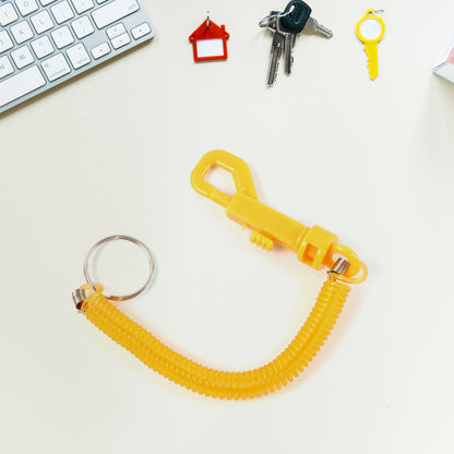 Coiled retractable keychain by Wukusy with metal clip, ideal for home improvement and key organization.