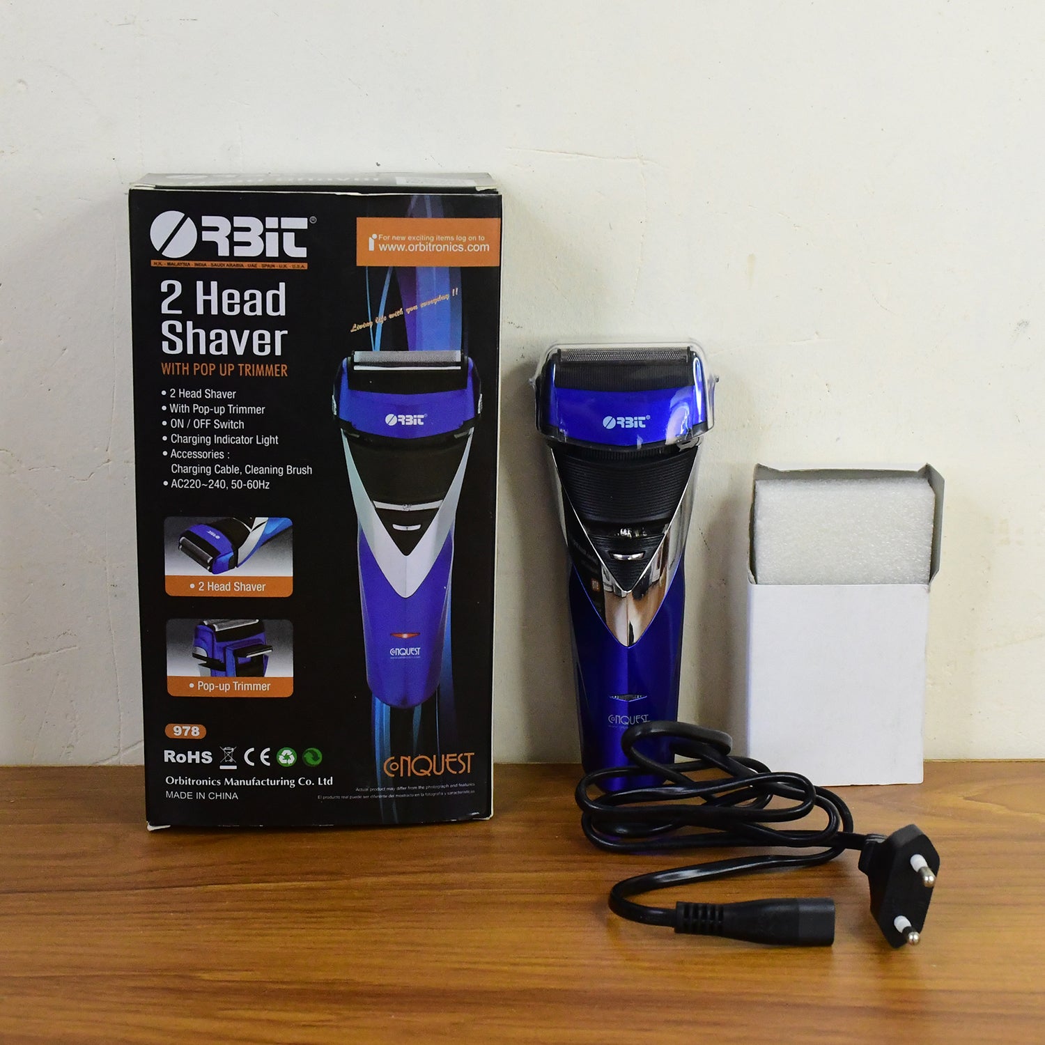 Wukusy Orbit rechargeable electric foil shaver with two heads and pop-up trimmer for face and body grooming.