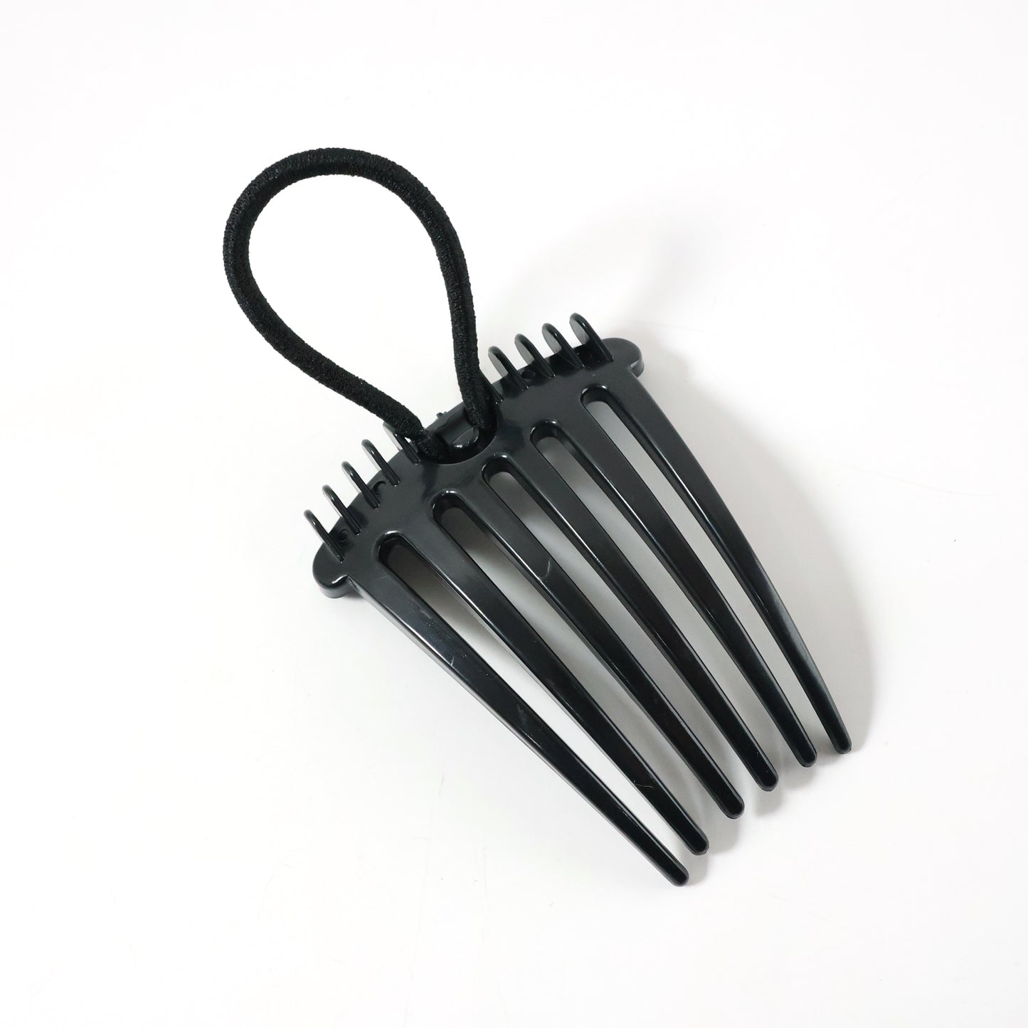 Wukusy volumizing hair bun comb clip, a black hair accessory for creating full, secure bun hairstyles.