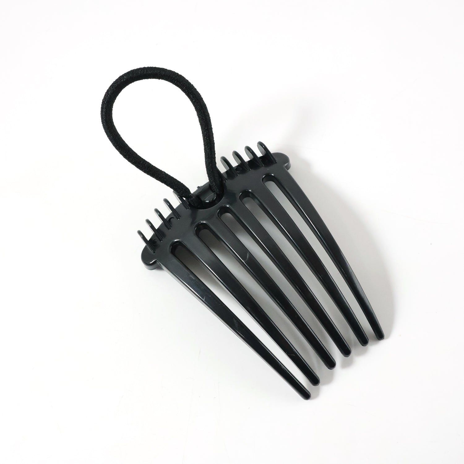 Wukusy volumizing hair bun comb clip, a black hair accessory for creating full, secure bun hairstyles.