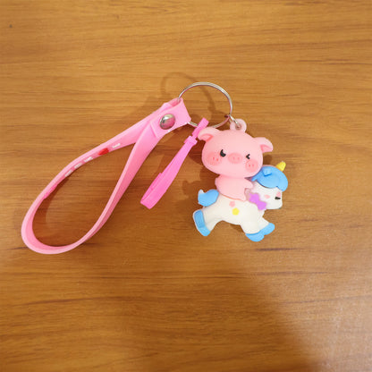 Cute pig riding a unicorn cartoon keychain by Wukusy, featuring colorful, playful design with detailed pig and unicorn charms.