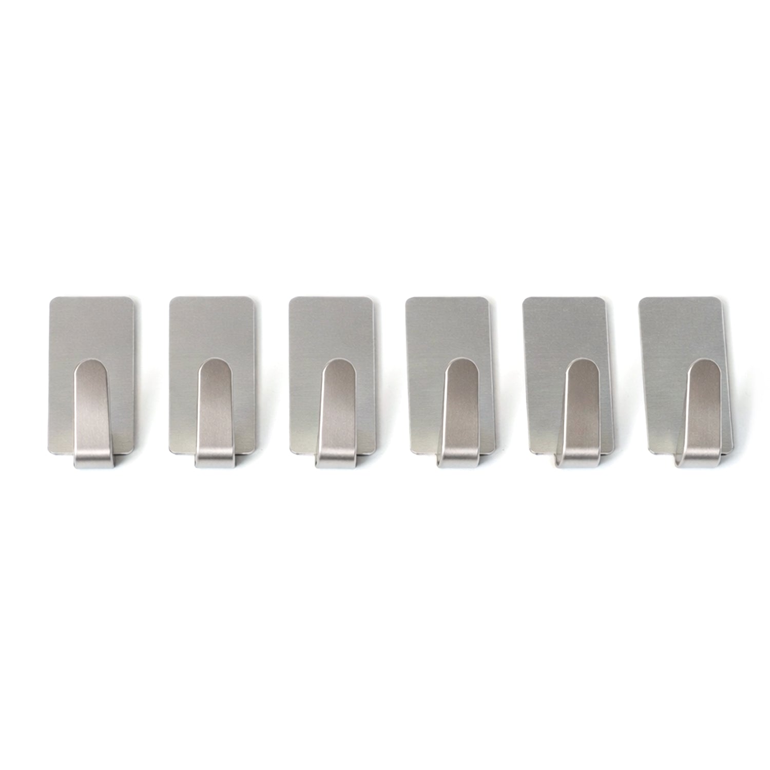 Set of six Wukusy self-adhesive wall hooks mounted on a wall, showcasing versatile hanging options for home organization.