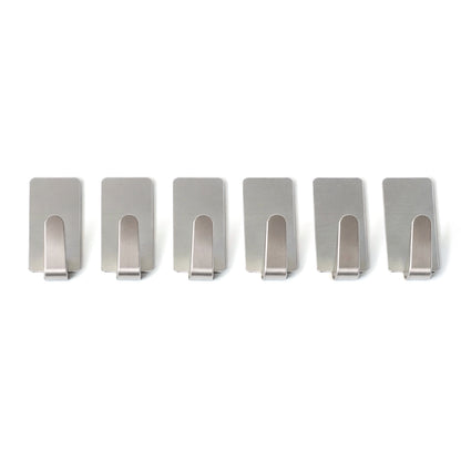 Set of six Wukusy self-adhesive wall hooks mounted on a wall, showcasing versatile hanging options for home organization.