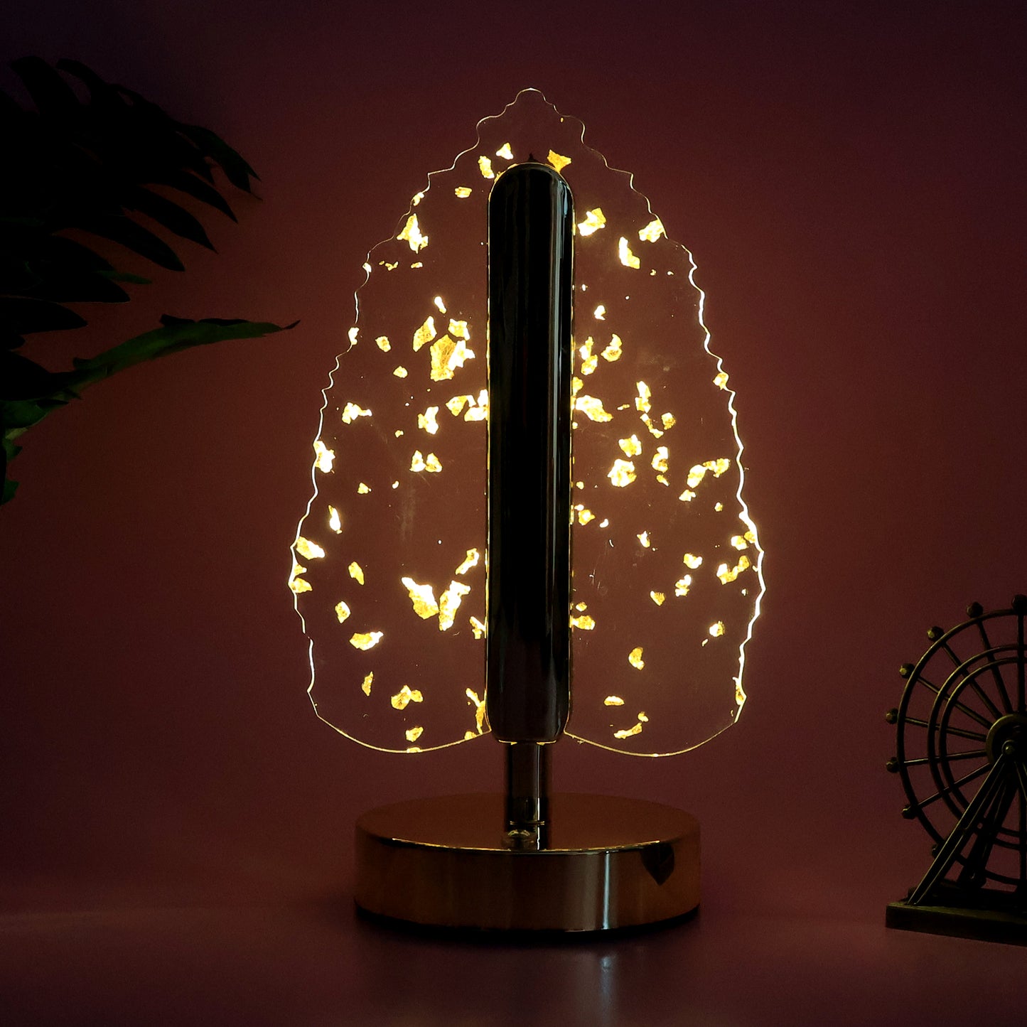 Golden crystal leaf-shaped LED table lamp by Wukusy, elegant home decor with warm ambient lighting.