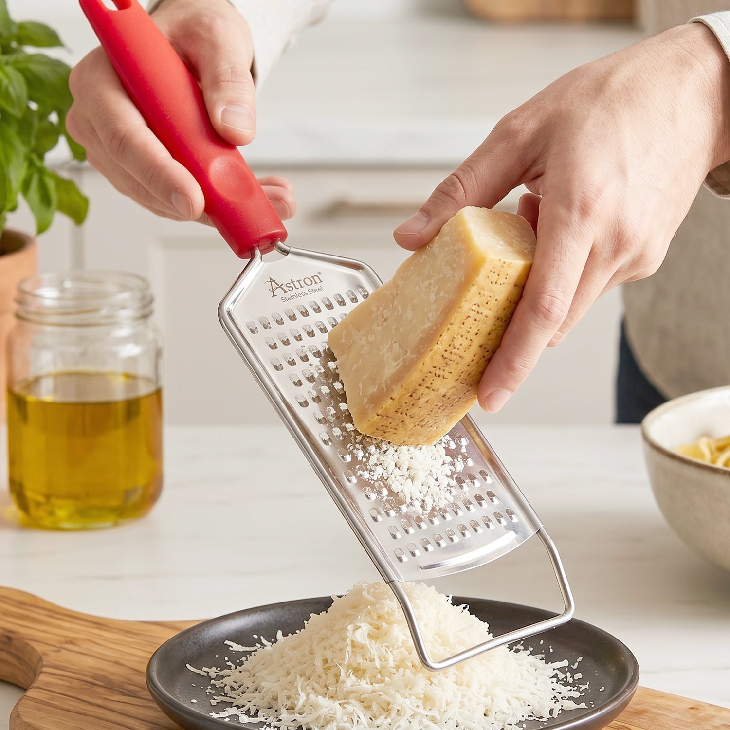Wukusy handheld cheese grater with plastic handle, ideal for grating cheese, vegetables, and lemon zest.