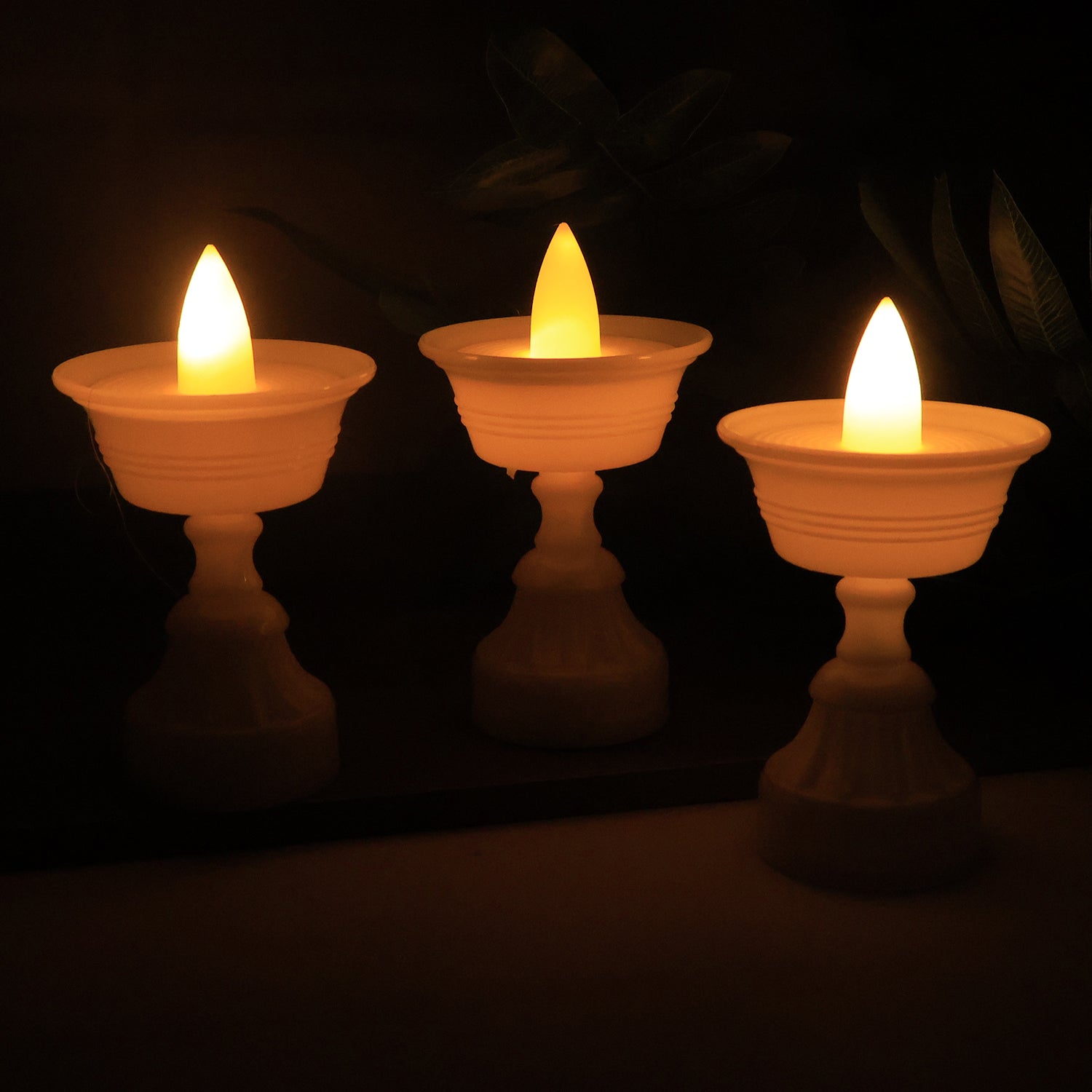 Set of 12 white water sensor LED diyas for home decor, featuring traditional diya design with modern LED illumination.