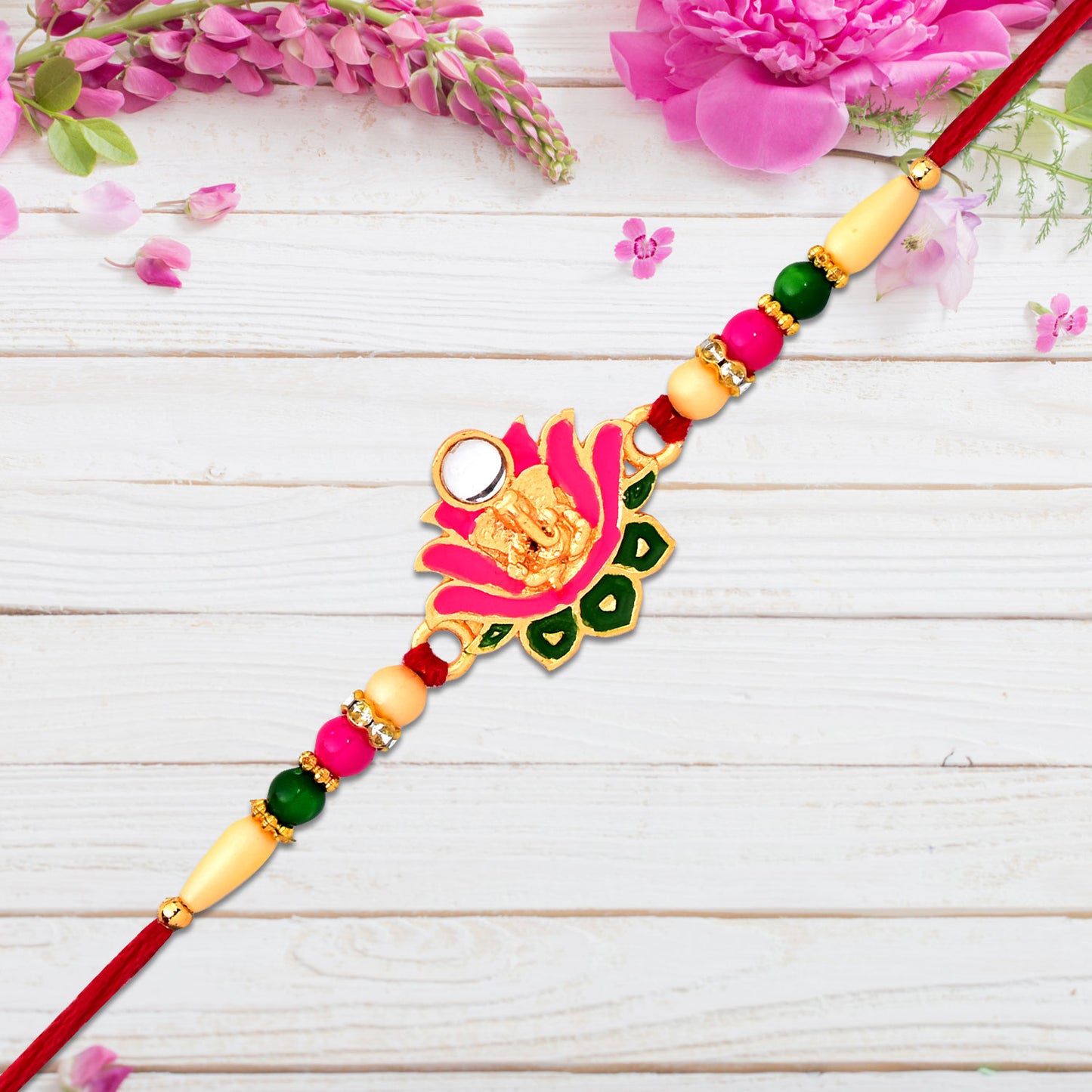 Wukusy Ganesh Rakhi featuring a lotus leaf motif with intricate designer details on a fashion accessory.