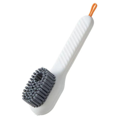 Wukusy multifunctional scrubbing brush with liquid soap dispenser and handle, used for shoe, cloth, and household cleaning.