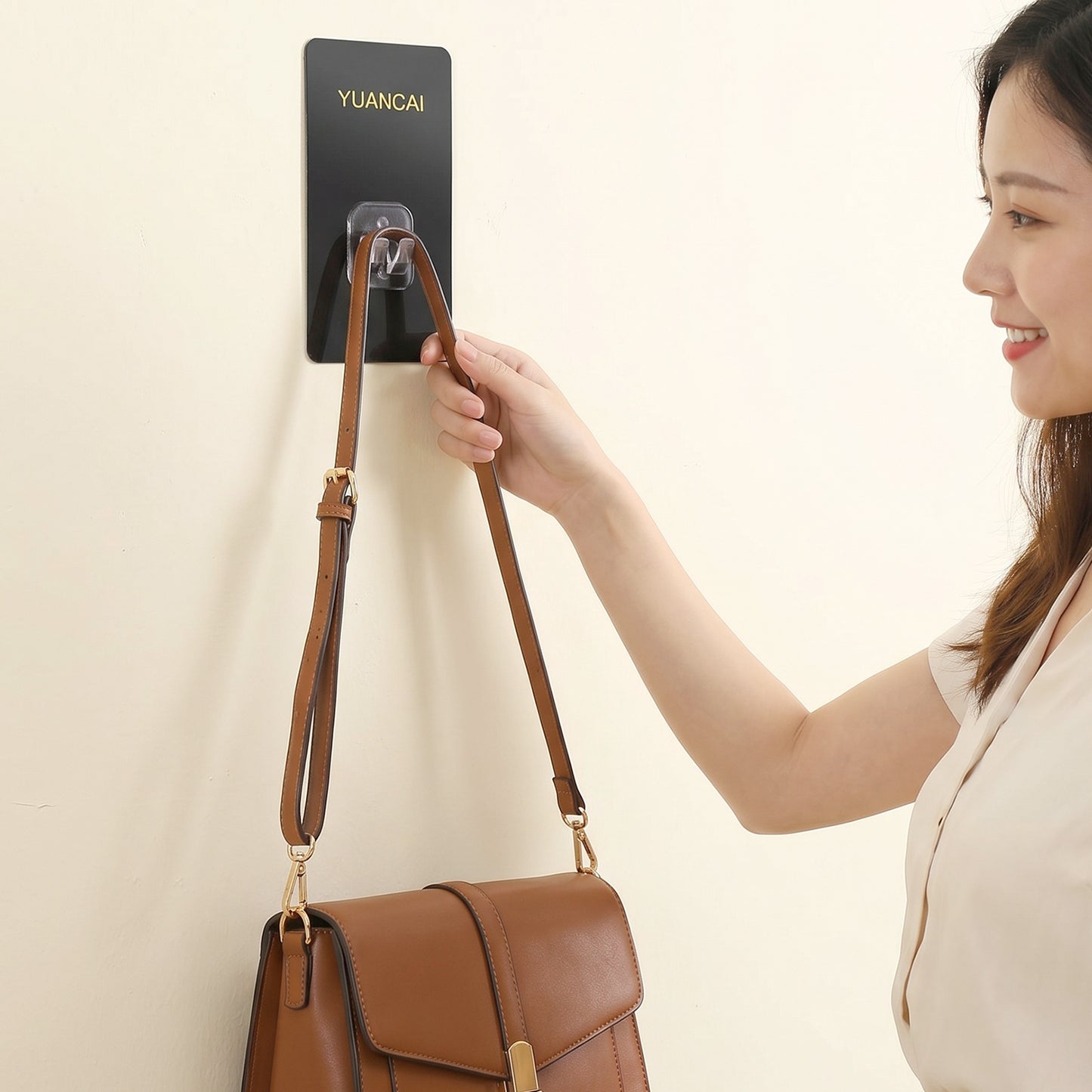 Wukusy adhesive plastic wall hook with strong hold self-stick hanger for storage, shown mounted on a wall.