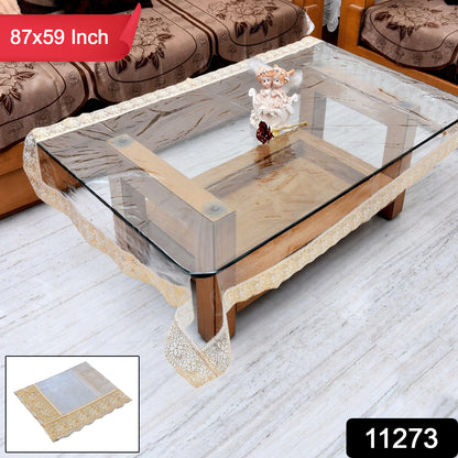 Transparent PVC table cover measuring 87x59 inches by Wukusy, showing smooth, clear plastic surface on a dining table.
