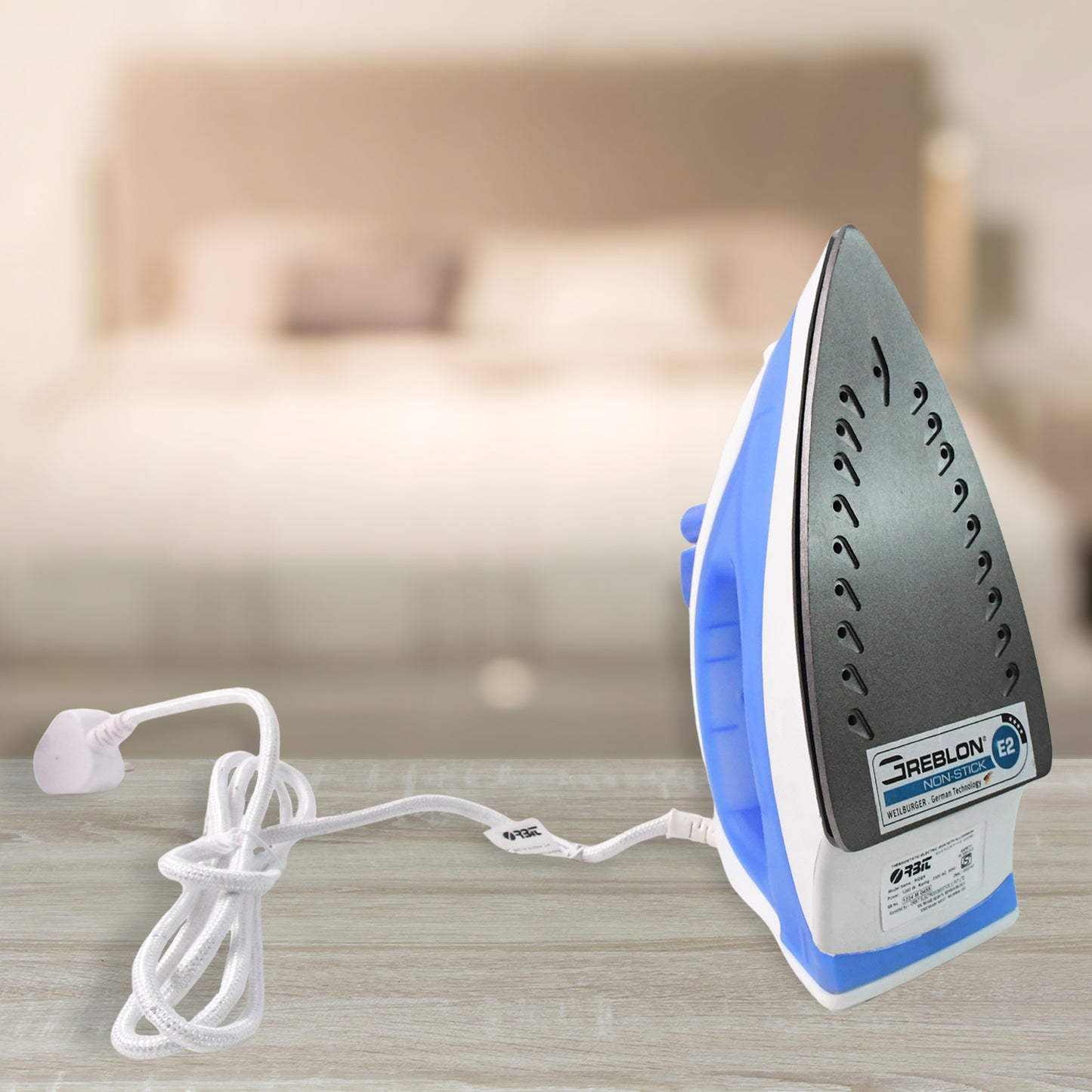 Wukusy Orbit high-performance 1200W steam iron with stainless steel soleplate and ergonomic handle on a white background.