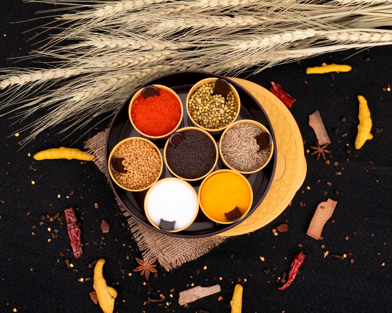 Wukusy 2509 round plastic masala spice box with multiple compartments for storing and organizing spices in the kitchen.