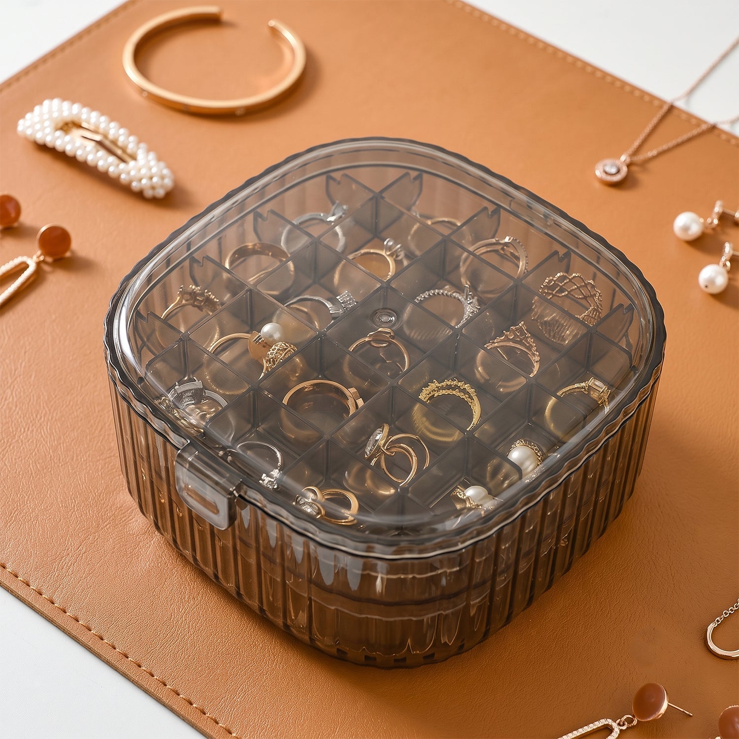 Stackable Wukusy plastic jewelry organizer box with multiple compartments for rings, earrings, and small accessories.
