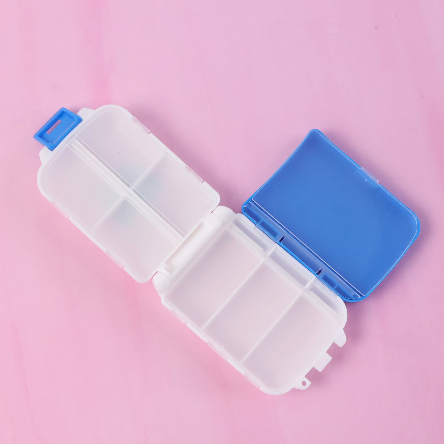 Blue Wukusy portable dual-sided pill organizer box with compartments for medication storage, compact and travel-friendly.