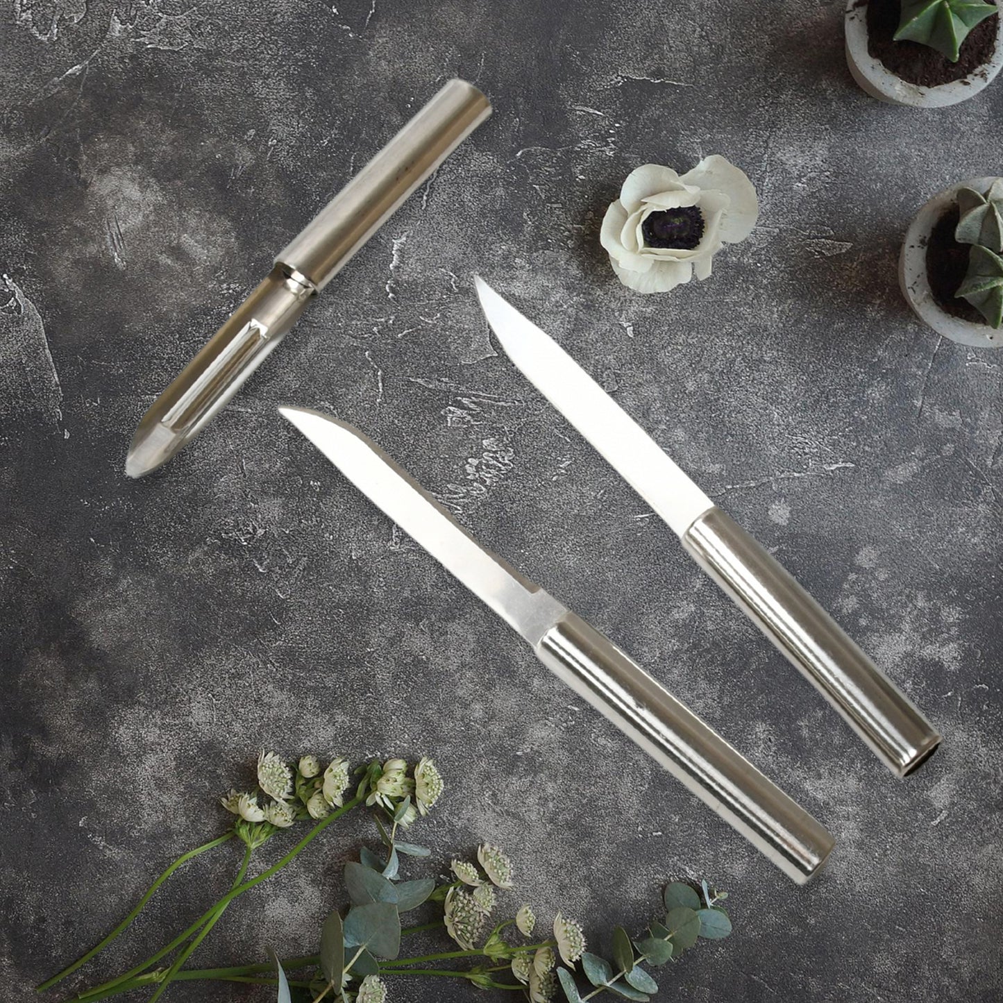 Set of three Wukusy stainless steel multipurpose knives with non-slip handles for fruit, meat, and vegetable chopping.