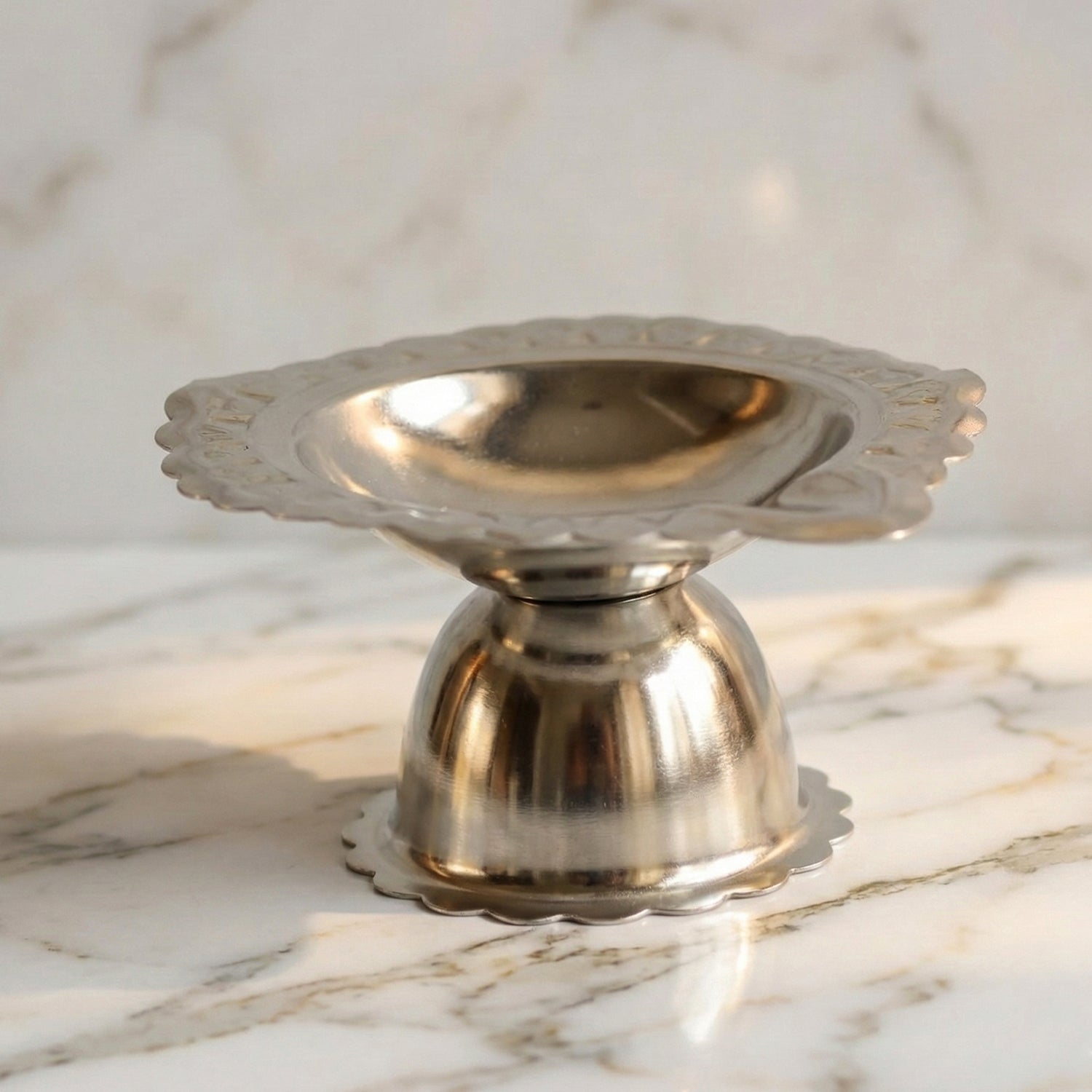 Stainless steel traditional Puja diya stand with multiple holders for oil lamps, designed for religious ceremonies.