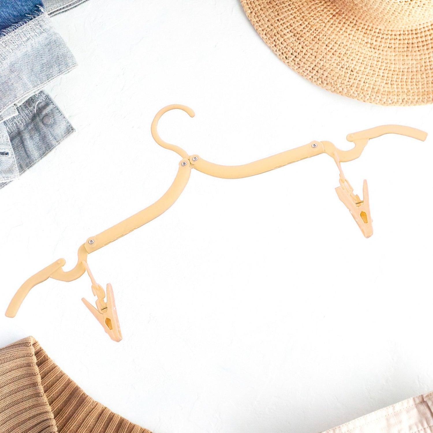 Wukusy folding clothes hanger with adjustable clips, ideal for hanging garments and organizing clothes efficiently.