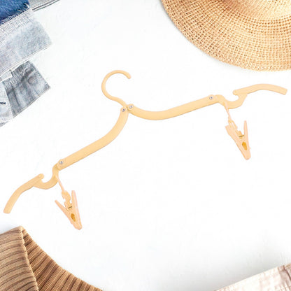 Wukusy folding clothes hanger with adjustable clips, ideal for hanging garments and organizing clothes efficiently.