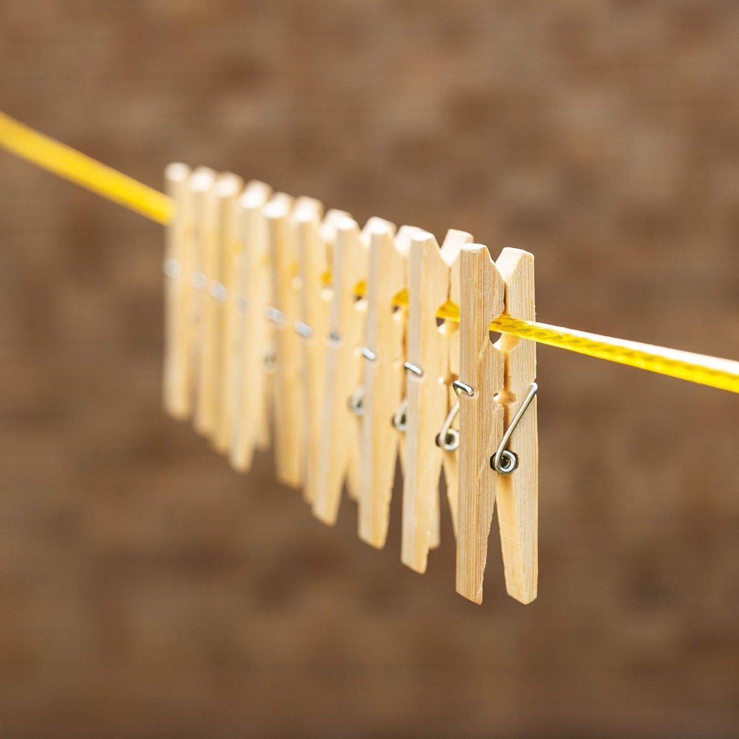 Wukusy heavy-duty bamboo wooden cloth clips pegs set of 10 for home improvement, shown holding laundry on a clothesline.