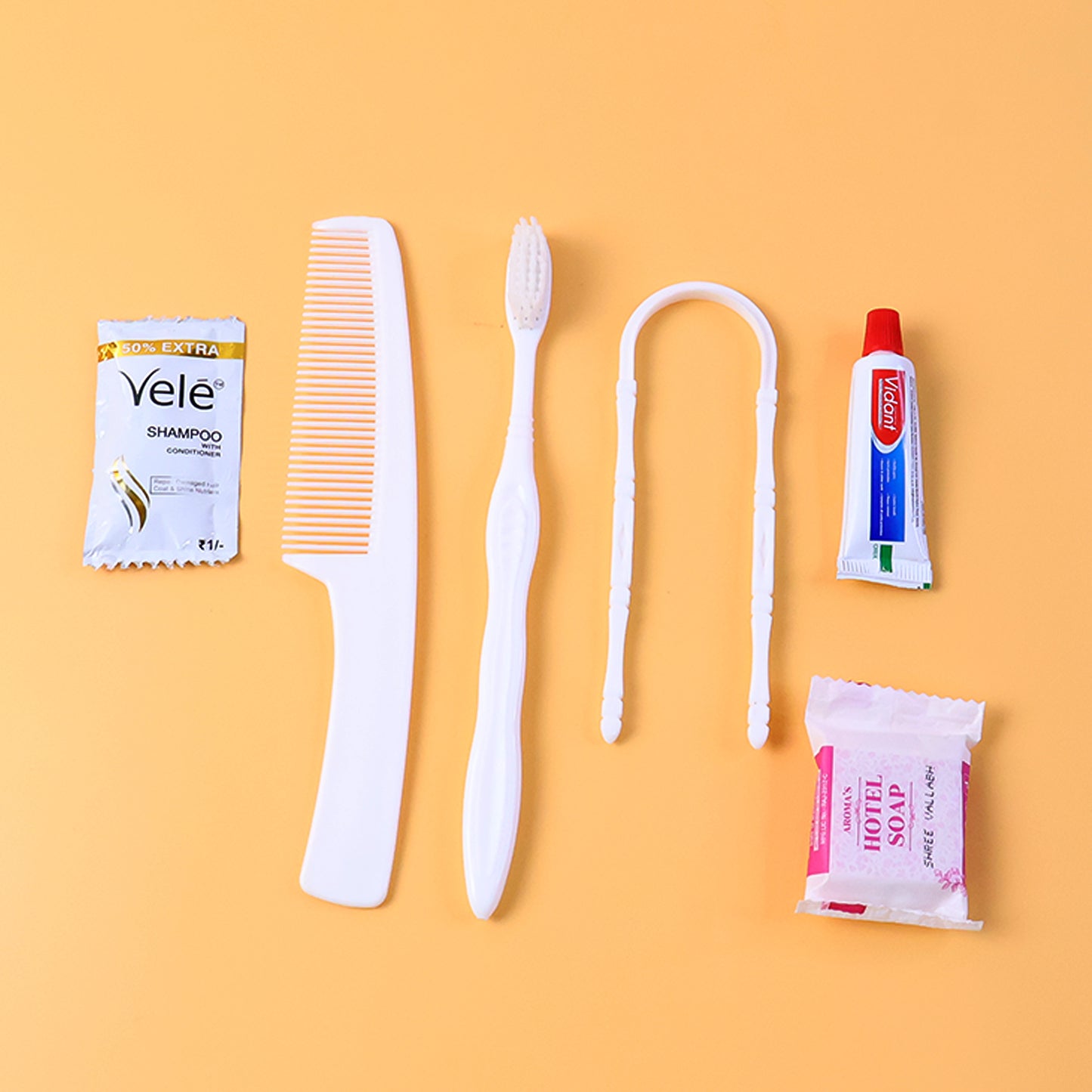 Wukusy 6-in-1 hotel guest toiletry kit with travel-sized bottles, comb, and personal care essentials in a compact set.