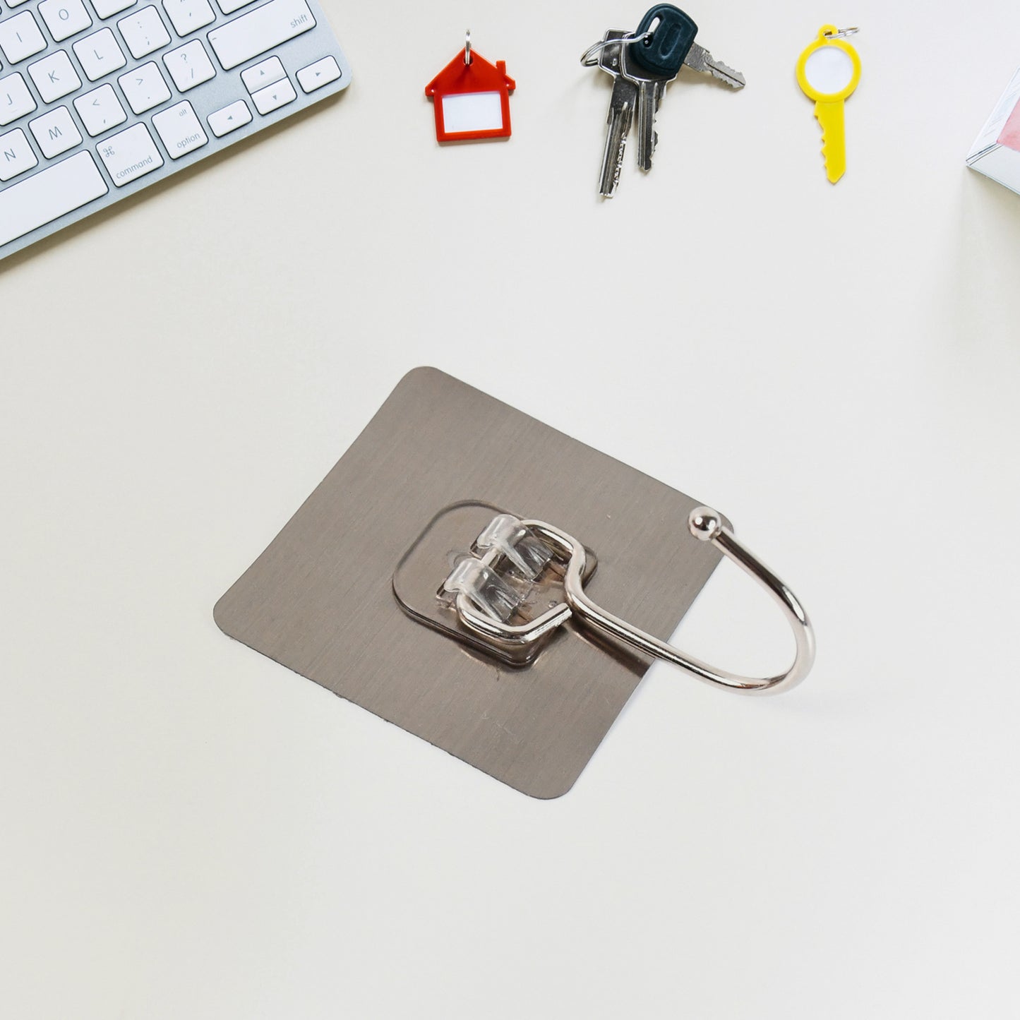 Large stainless steel self-adhesive wall hook from Wukusy, ideal for home and kitchen organization, shown attached to a wall.