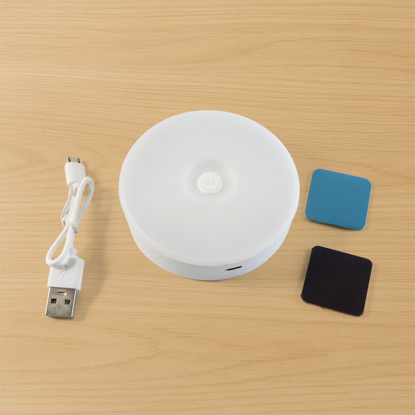 Wukusy rechargeable motion sensor night light illuminating a dark hallway with a sleek, compact design.
