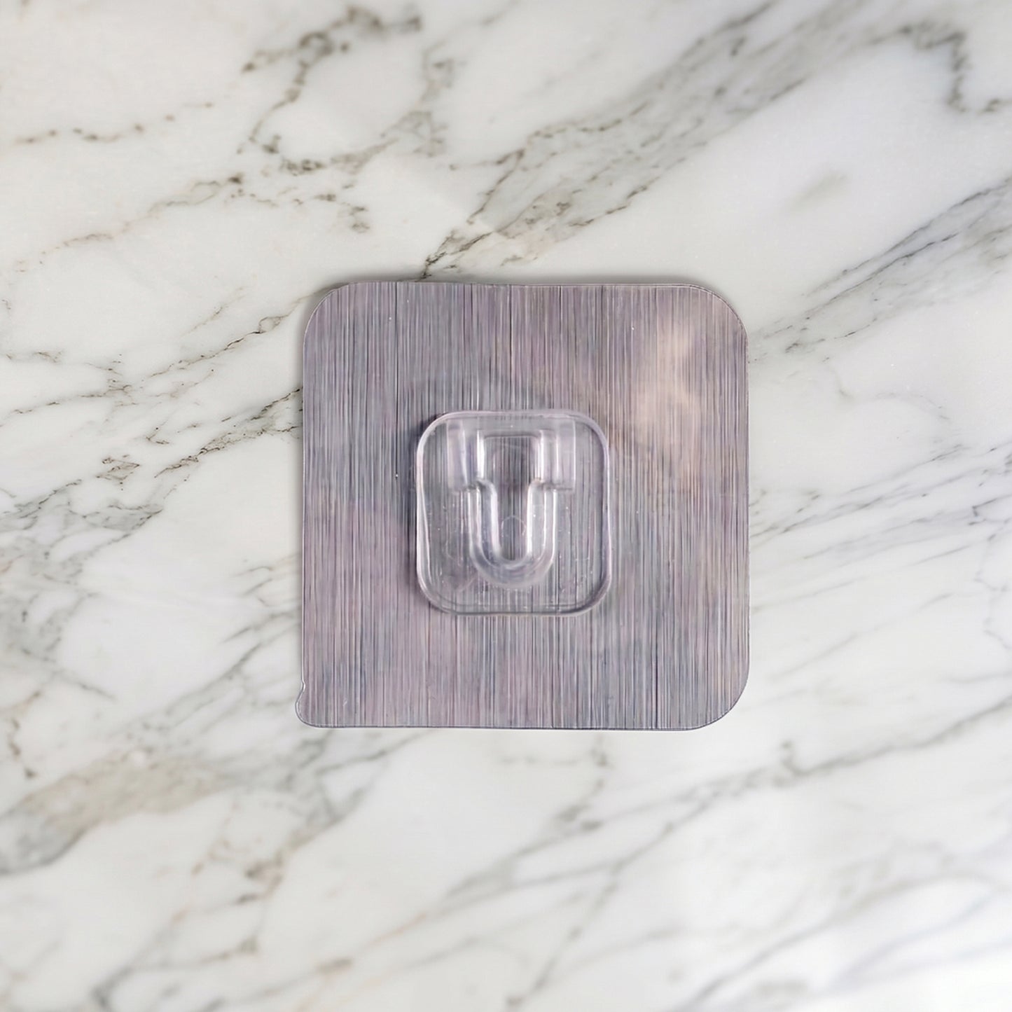 Wukusy heavy duty self-adhesive utility wall hook attached to a wall, holding a towel or small items for organization.