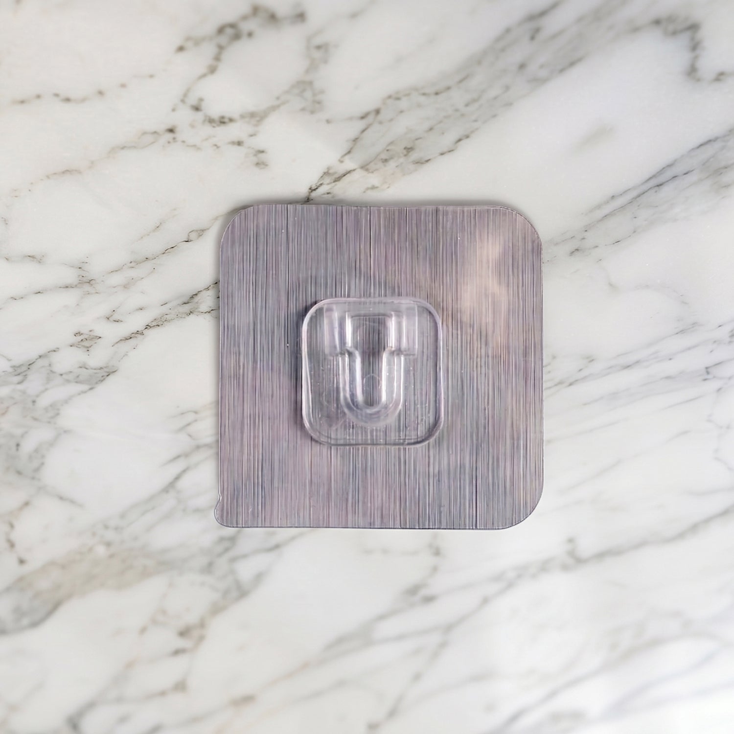 Wukusy heavy duty self-adhesive utility wall hook attached to a wall, holding a towel or small items for organization.