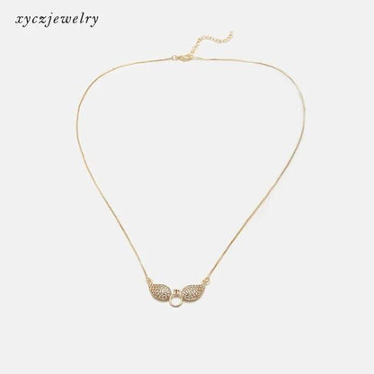 Gold Salty Angel Wings Necklace with intricate wing design, crafted by Drpshippr, perfect for elegant jewelry styling.