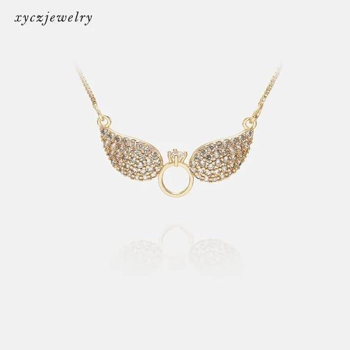 Gold Salty Angel Wings Necklace by Drpshippr featuring detailed angel wing pendant on a delicate chain.
